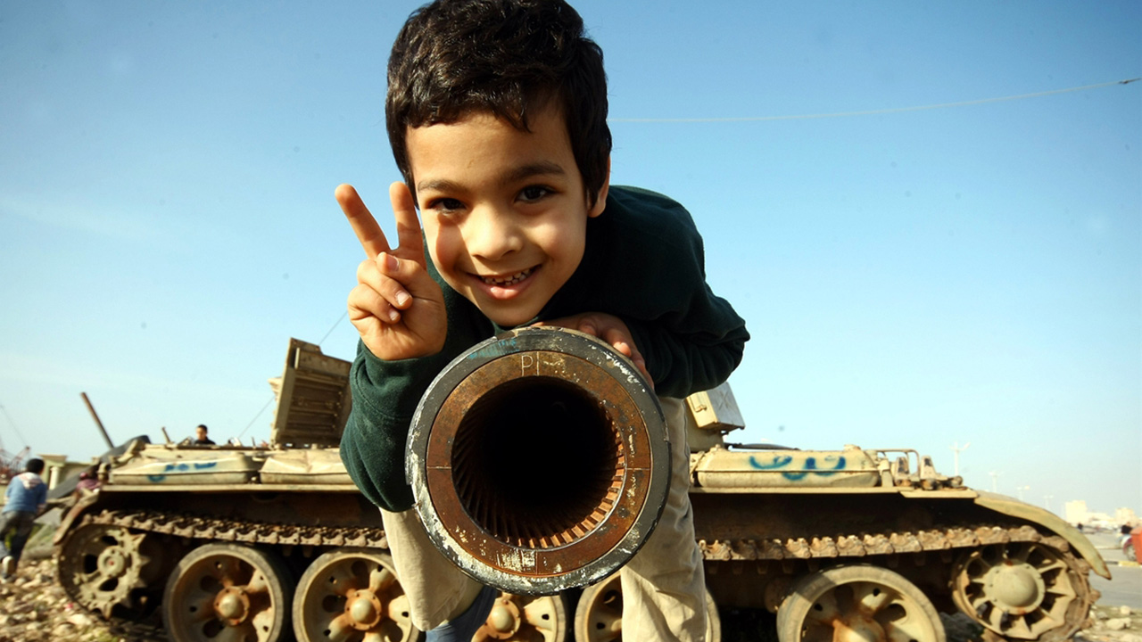 4 Mart 2011`de Libya`nın en büyük şehirlerinden Bingazi`deki halk ayaklanmasının ardından muhaliflerin ele geçirdiği tanklar çocukların oyuncağı oldu. (Arşiv)