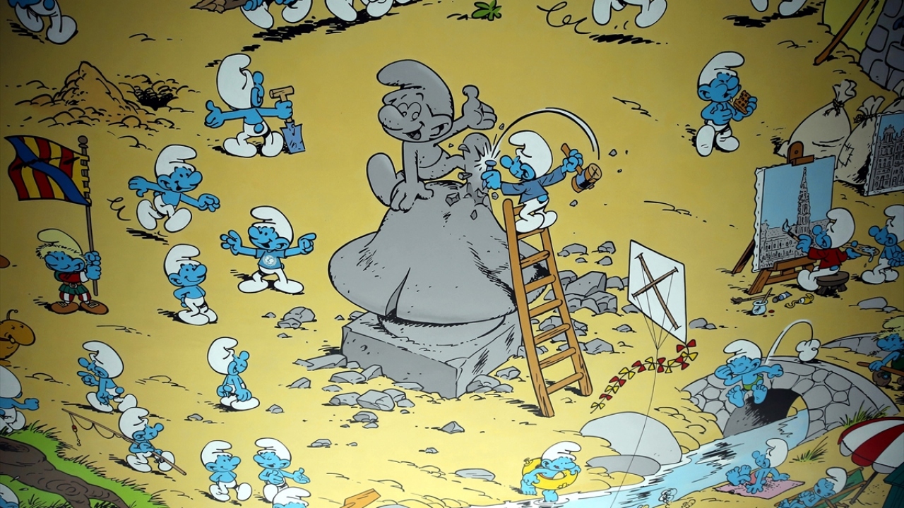 Şirinler köyünün çizildiği duvarda ise anıt bina Atomium ve patates kızartması gibi ünü ülke sınırlarını aşan detaylara rastlanıyor.