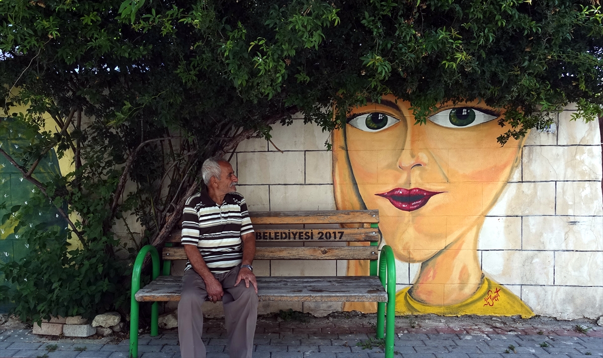 Gönüllü olarak işe başlayarak sanatını ilçe sokaklarını güzelleştirmek için kullanan Sürgit, 1 yıldan beri Altınözü`nde boş duvarlara anlamlı resimler çiziyor. 