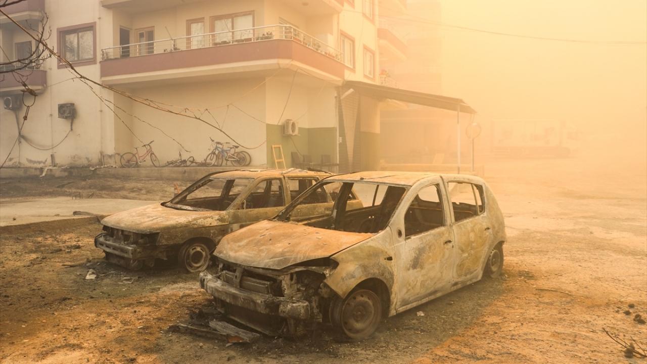 Bir bina ile önünde duran araçlar yangın nedeniyle zarar gördü.