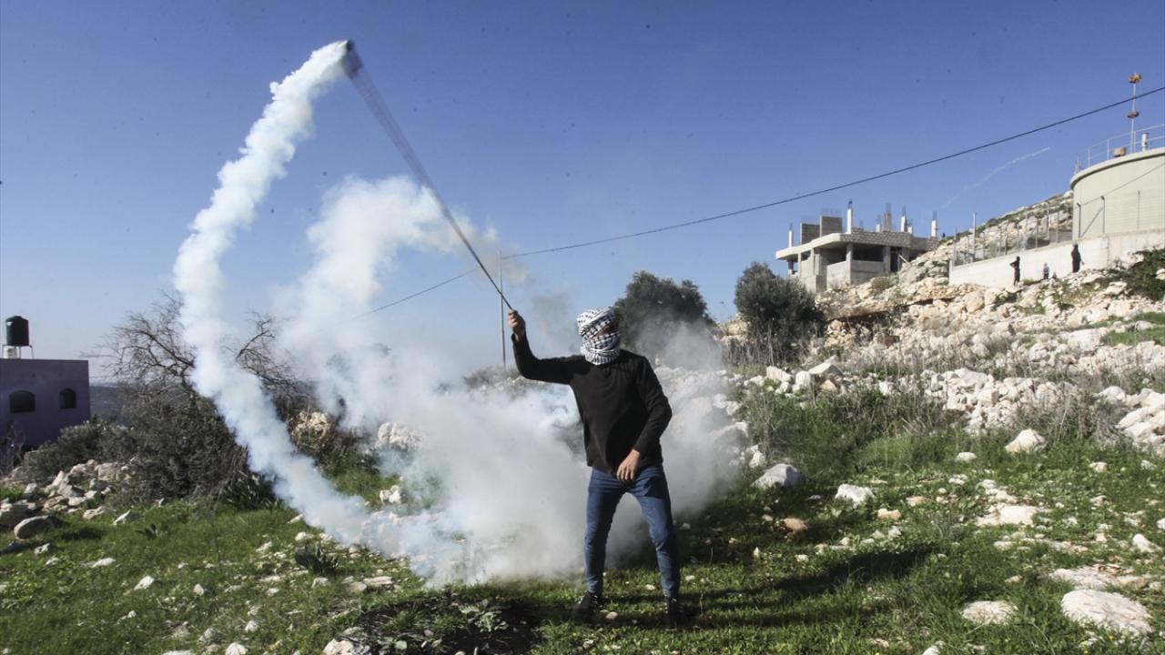 İsrail güçlerinin göstericilere göz yaşartıcı gaz bombasıyla müdahale etmesi üzerine göstericiler taş atarak karşılık verdi.