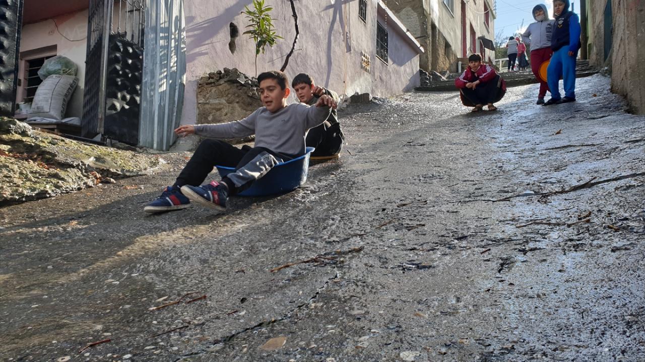 Şehit İbrahim Kundakçı Mahallesi`nde çocuklar, evlerinden getirdiği leğenlerle trafiğe kapalı yokuş yolda kayarak eğlendi.