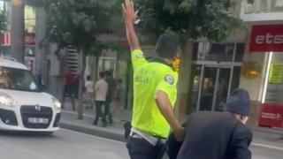 Polis, trafiği durdurup yaşlı adamı yolun karşısına geçirdi