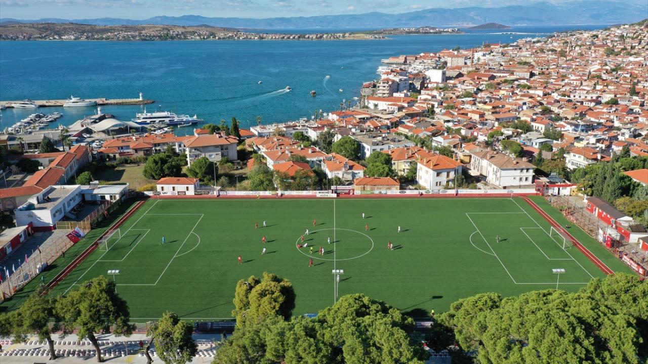 Ağaçların gölgesinde deniz manzaralı tribünde maç keyfi