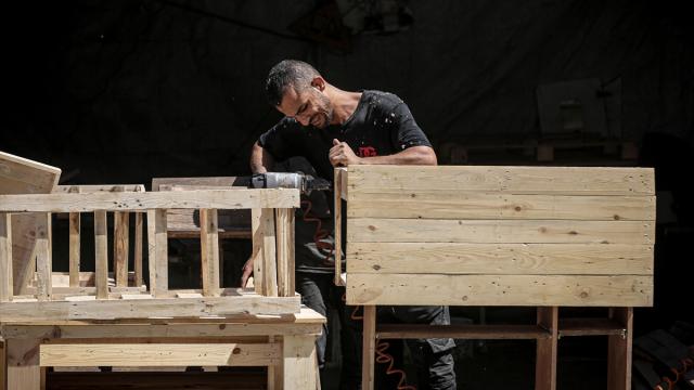 Gazzeli marangoz, yardım paletlerinden çocuklar için okul sırası üretiyor